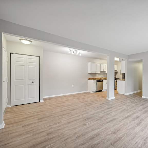 the living room and kitchen in a new home with wood flooring at renew odenton