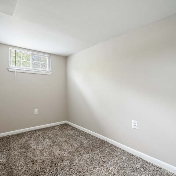 an empty room with carpet and a window at renew odenton