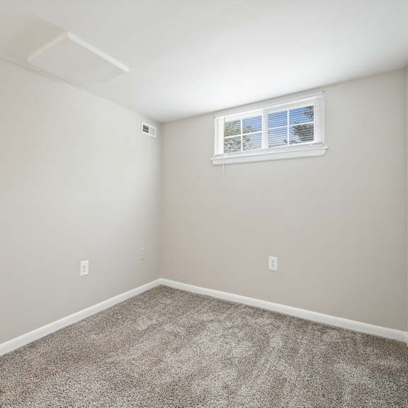 an empty room with carpet and a window at renew odenton