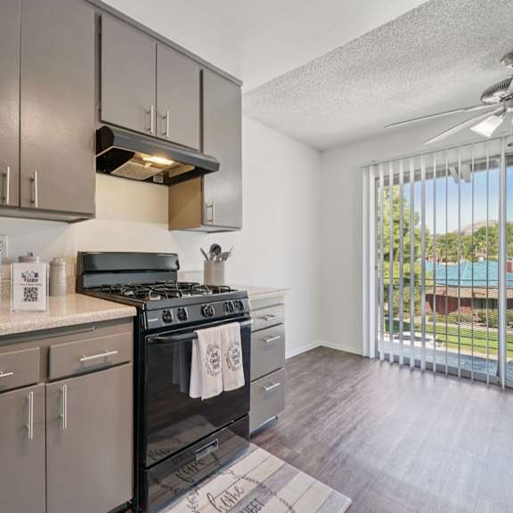 a modern kitchen with a black stove top oven.