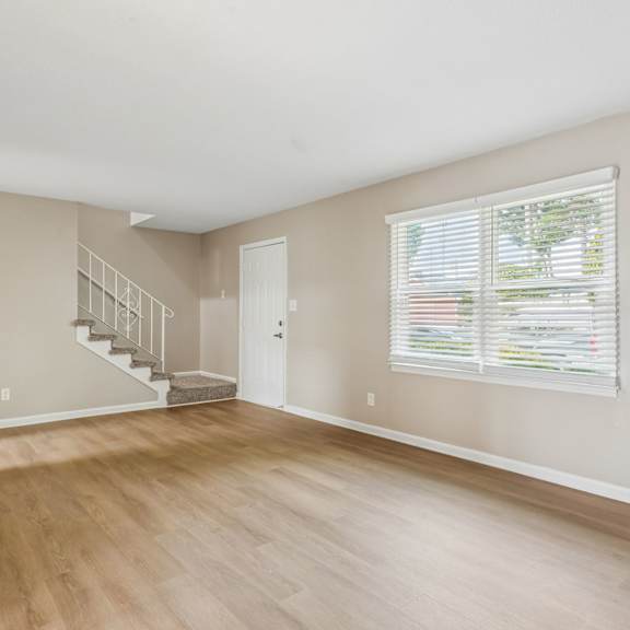 a room with wooden floors and a staircase.