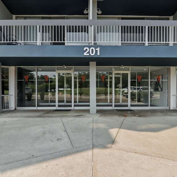 the image shows the front of a building with the number 201 on it.