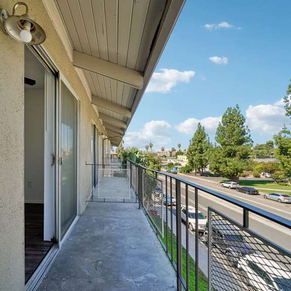 a balcony with a metal railing and a concrete floor.