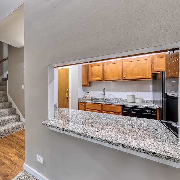 room with a glimpse into the kitchen and carpeted staircase at oak park city, oak park, il 60301