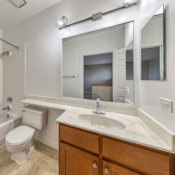 a white bathroom with a toilet, sink, and bathtub. at oak park city, oak park, 60301