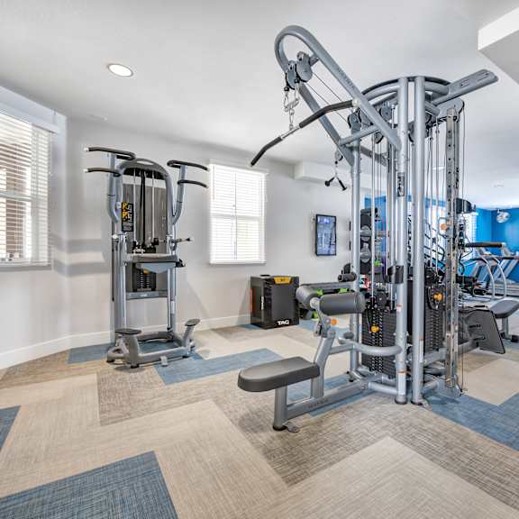 a workout room with a variety of exercise equipment