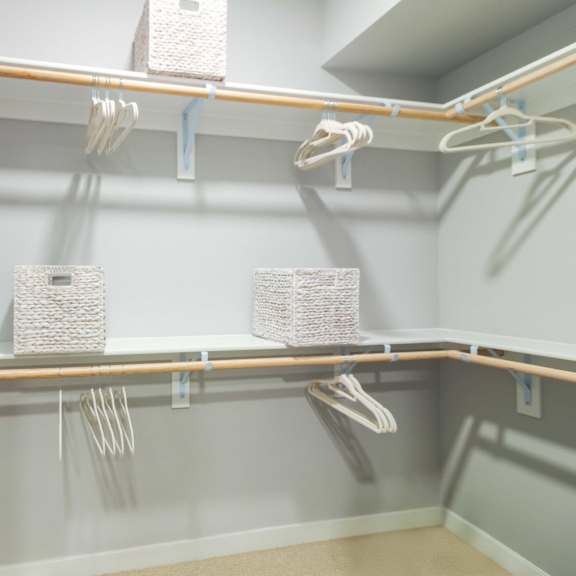 a walk-in closet with shelves and racks