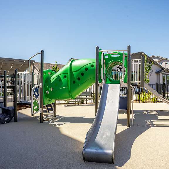 a playground with a green slide