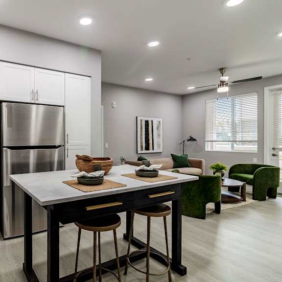 a modern kitchen with a table and chairs.