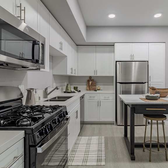 a modern kitchen with a black and white checkered floor.