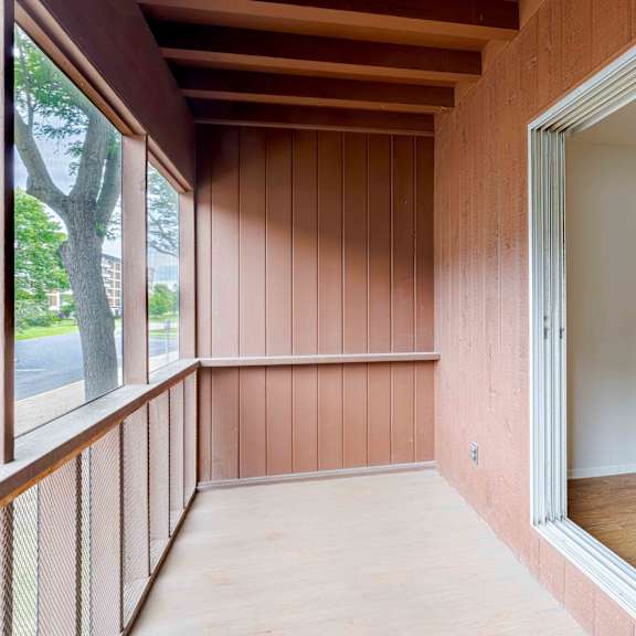 a room with wooden walls and a glass door.