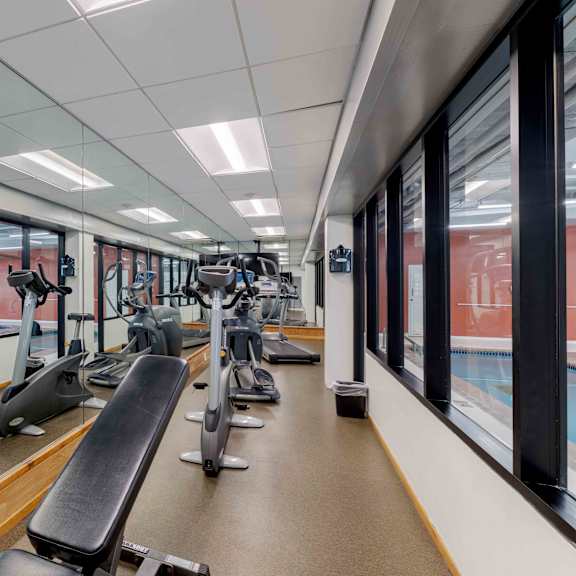 a gym with treadmills and exercise equipment.