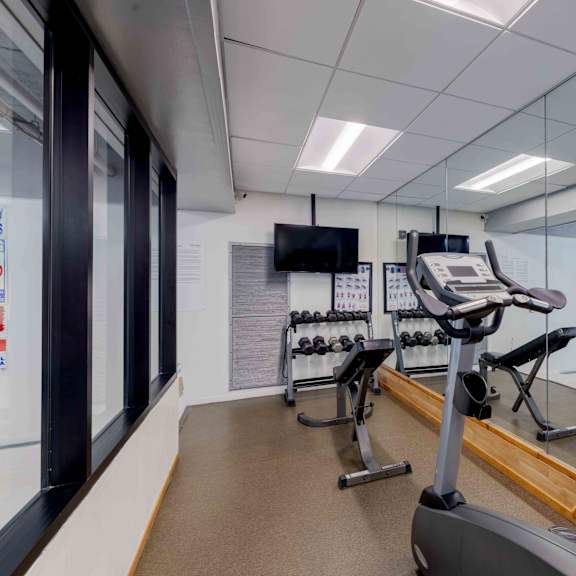 a gym with treadmills and exercise bikes.