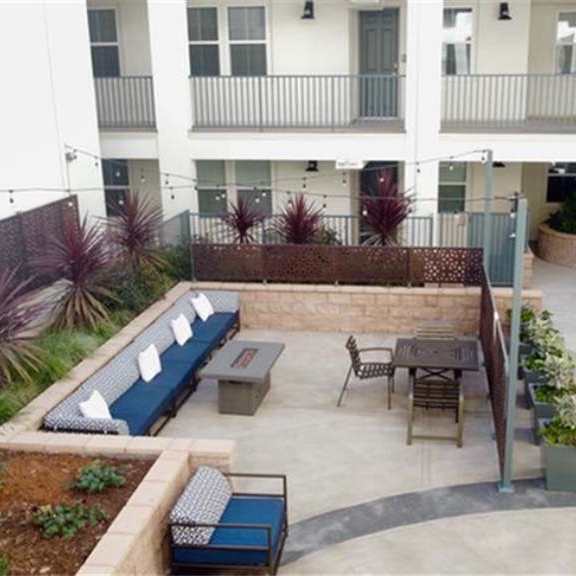 a patio with a table and chairs in front of a building at arrive los carneros ii, california, 93117