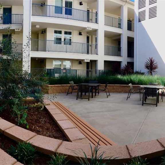 a patio with tables and chairs in front of a building at arrive los carneros ii, goleta, ca