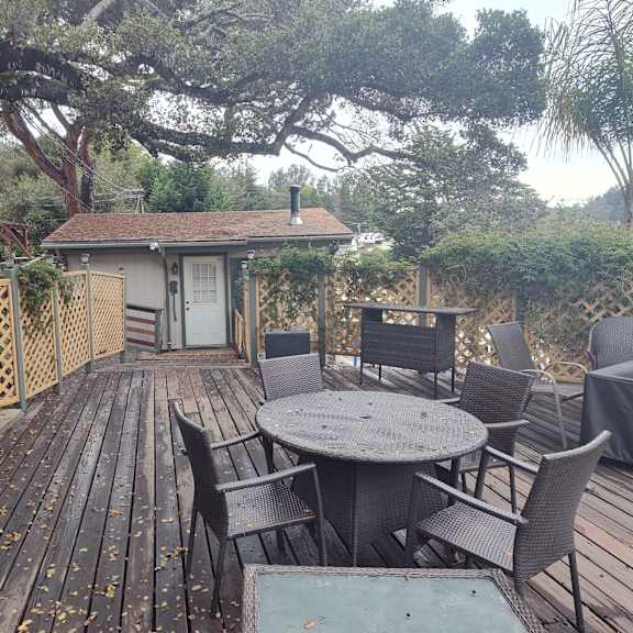 a wooden deck with a table and chairs at salinas sunset apartments, salinas, california