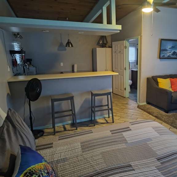 a living room with a couch and kitchen at salinas sunset apartments, salinas