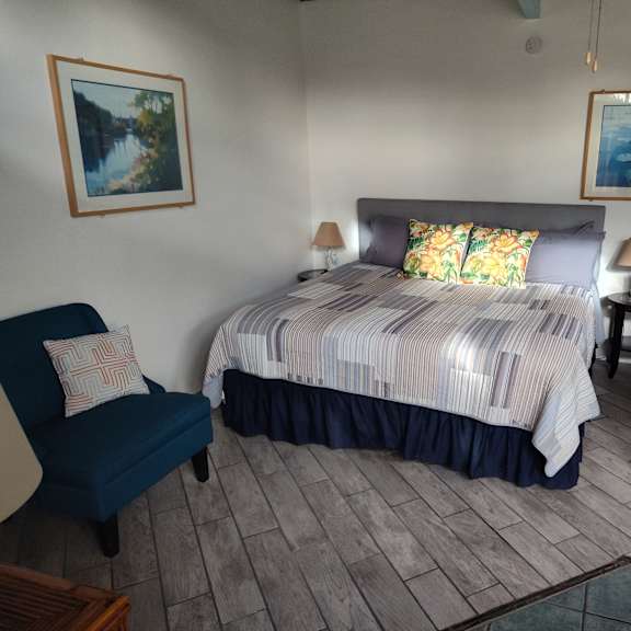 a bedroom with a bed, chair, and two lamps at salinas sunset apartments, salinas, 93907