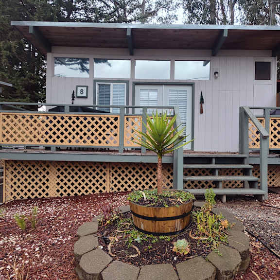 cabin with a wooden deck and a potted plant in front at salinas sunset apartments, california, 93907