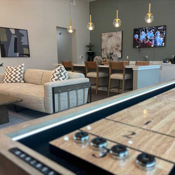 clubhouse with shuffleboard table and a kitchen with a television