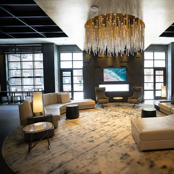 large common area with sofas, chairs and windows