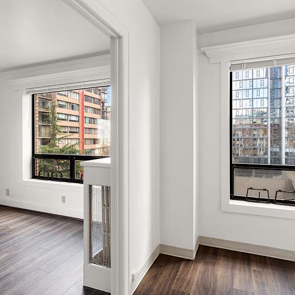 a room with a window overlooking a city street at the exeter apartments, seattle, 98101