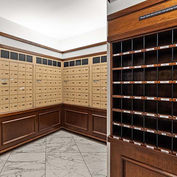 a room with a wall of mailboxes and a marble floor at the exeter apartments, apartments, seattle, wa