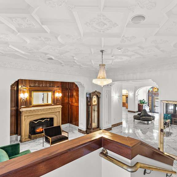 a large, elegant room with a fireplace and a mirror on the wall at the exeter apartments, washington