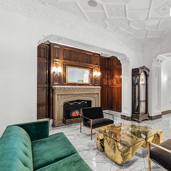 a living room with a fireplace and a green sofa at the exeter apartments, washington