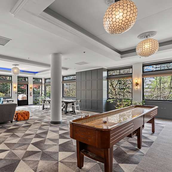 a game table is in the middle of a room with a checkered floor at the exeter apartments, washington, 98101