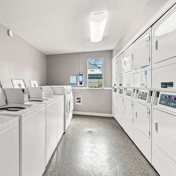 a row of washing machines in a laundromat.