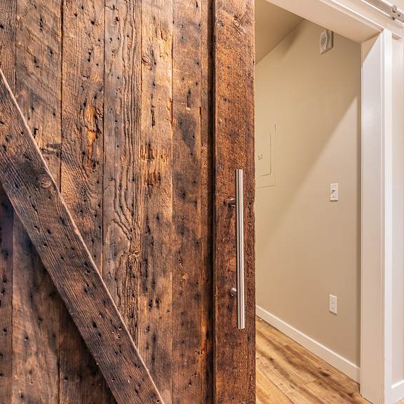 rustic barn door with modern hallway entrance at brooklyn yard apartments, portland