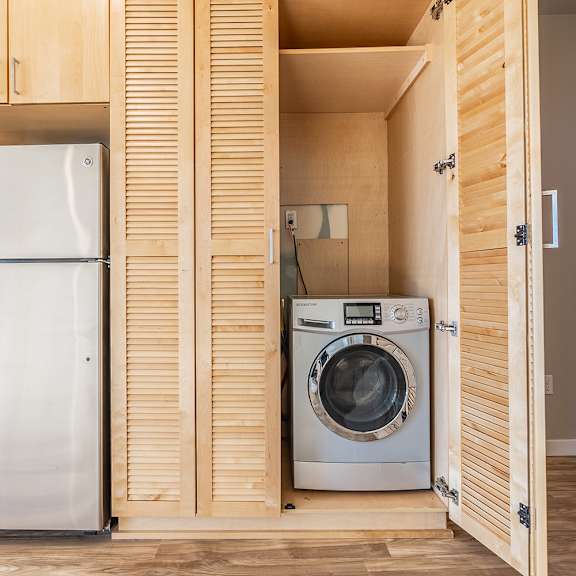 in unit washer and dryer in cabinet storage at brooklyn yard apartments, portland, or 97202