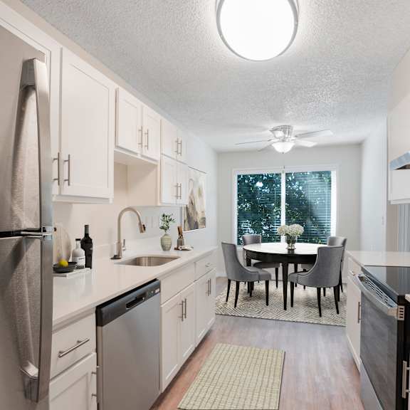 a kitchen with a table and chairs in the middle.