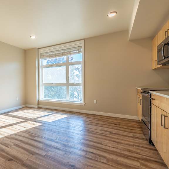 empty living space with large window and natural light at brooklyn yard apartments, portland, 97202