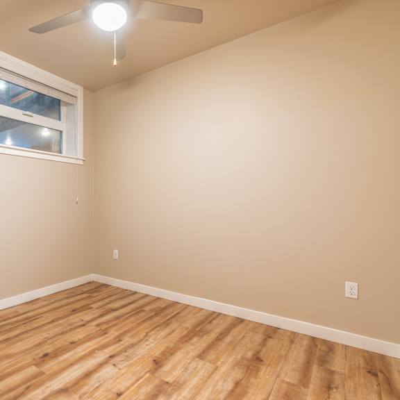 empty bedroom with window and hardwood flooring at brooklyn yard apartments, portland, oregon