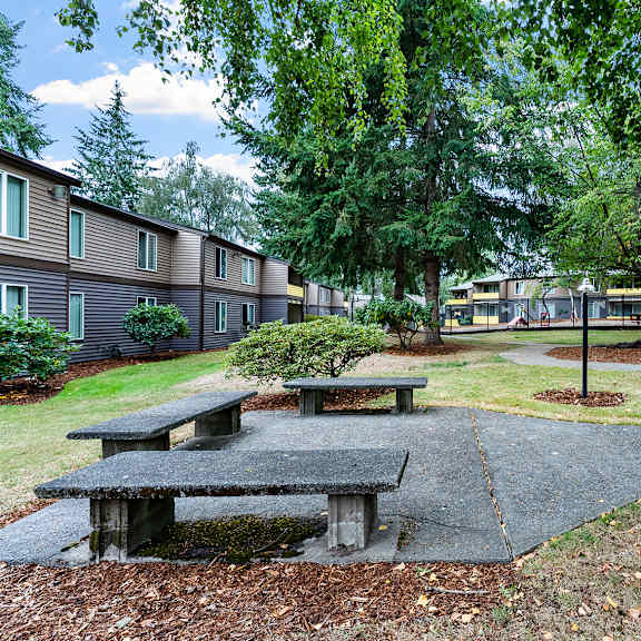 courtyard with tables and apartment buildings in the background