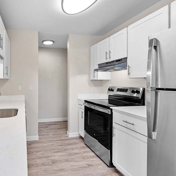 a kitchen with white appliances and cabinets.