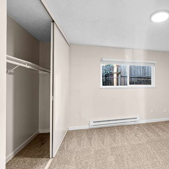 bedroom with a window and a closet