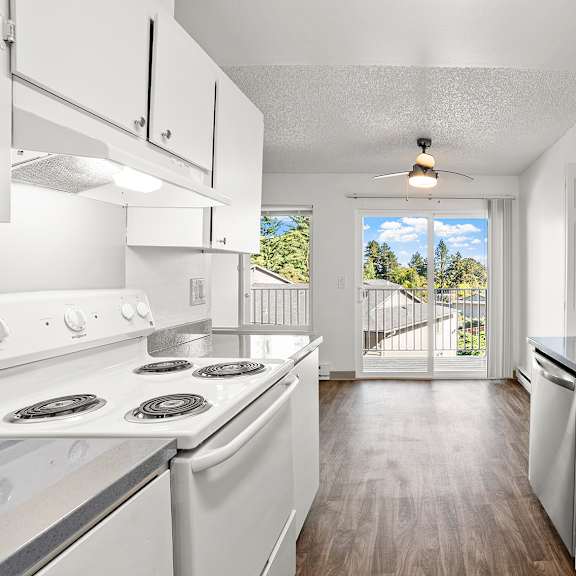a kitchen with white appliances and cabinets.