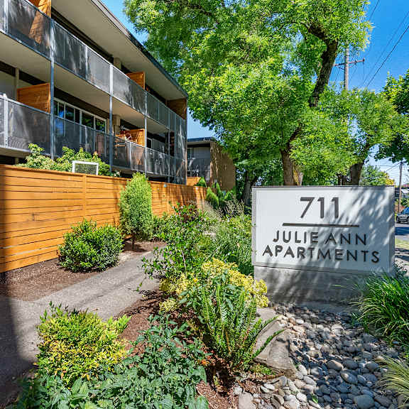 a sign for julie ann apartments is in front of a building.