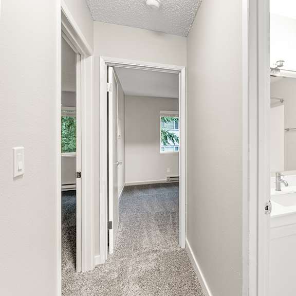a bathroom with a toilet, sink, and mirror.