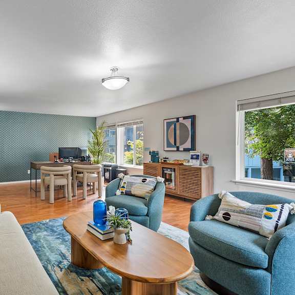 a living room with a couch, chairs, and a coffee table.