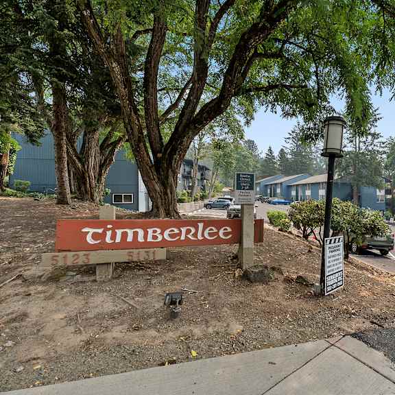 a timberlee sign is in front of a tree.