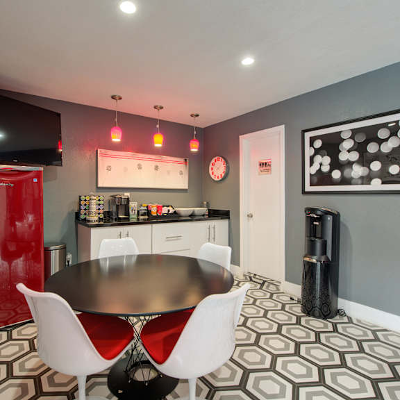 a room with a table and chairs and a television at dwell apartment homes, riverside, 92507