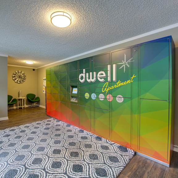 a room with a rug and a large sign on the wall at dwell apartment homes, riverside, ca