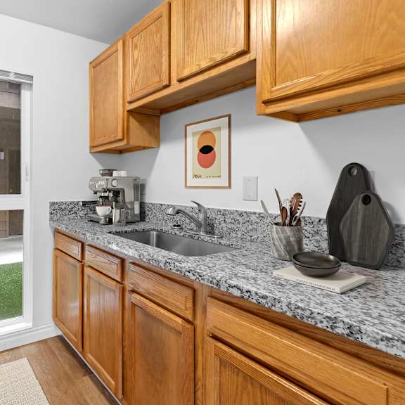 a kitchen with wooden cabinets and a granite countertop.