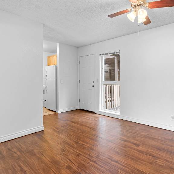 a room with a ceiling fan and wooden floors.at east wind, gresham, or 97030
