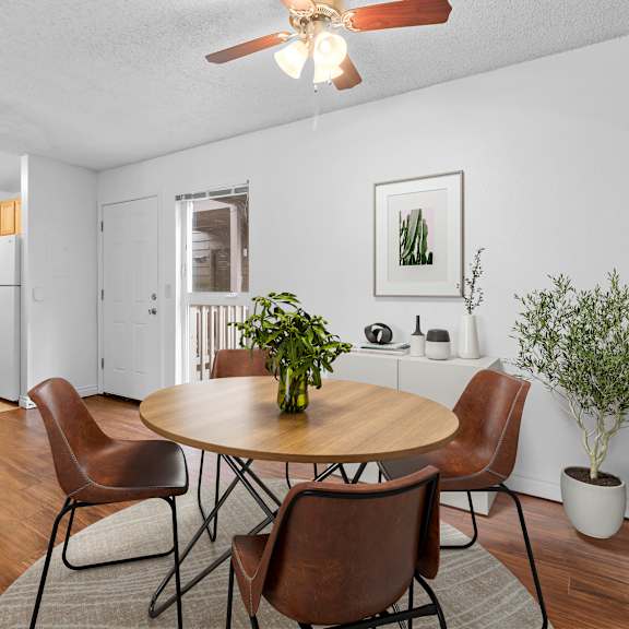 a dining room with a round table and chairs.