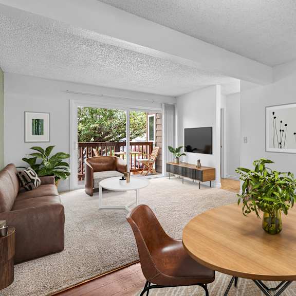 a living room with a brown table and chairs.